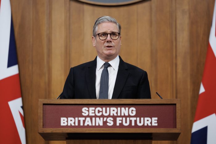 Prime Minister Sir Keir Starmer stands in front of a lectern reading "Securing Britain's future"