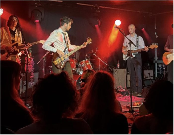 Band 'A Man is Scared' performing. Shows the whole band