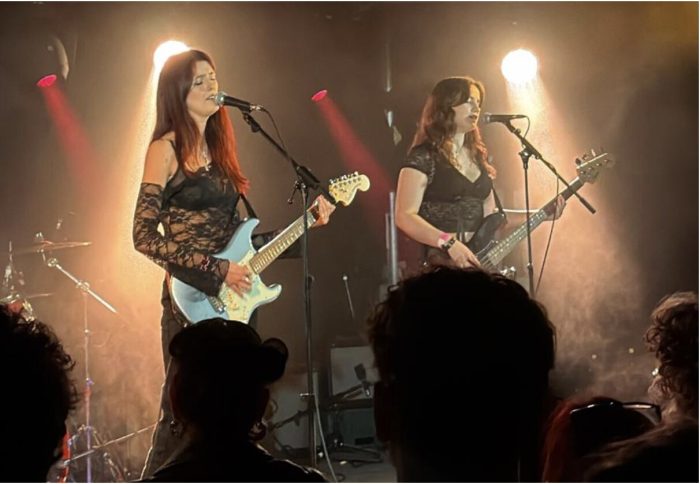 Band 'B*tchcraft' performing. Shows lead singer with guitar and bassist