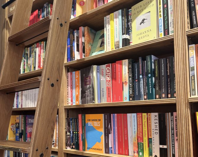 Bookshelves in the fiction section with a ladder leaning against it
